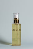 OmVeda Botanical Boost hair oil bottle with gold pump, clear yellow oil