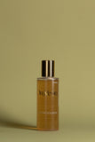 OmVeda clarifying solution bottle with gold cap and amber liquid