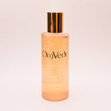 OmVeda clarifying solution 100ml translucent amber bottle with gold cap, front view