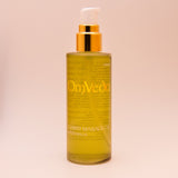 Body oil bottle, 100ml, amber liquid with gold pump and OmVeda label
