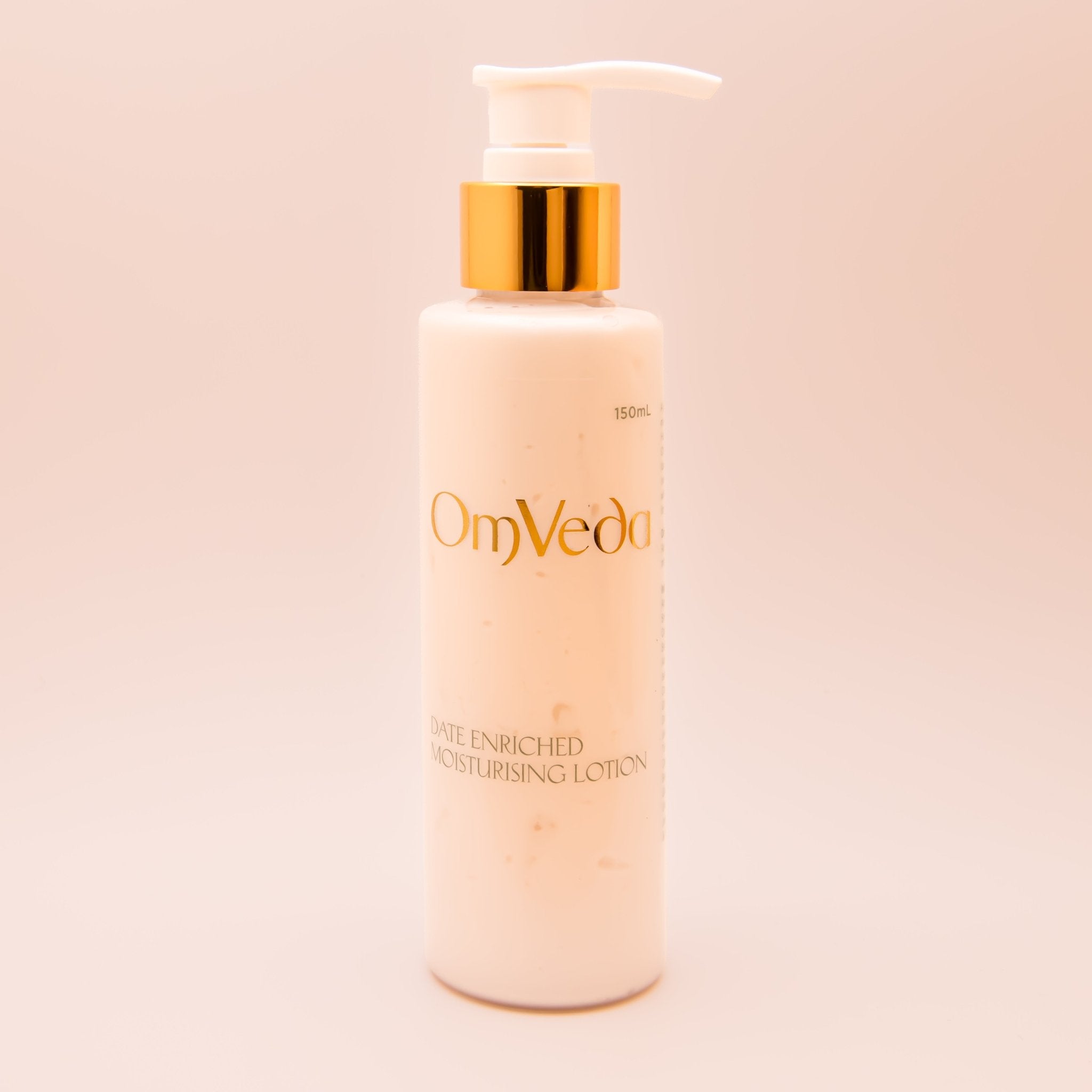 OmVeda moisturising lotion bottle with pump, white bottle and golden pump top