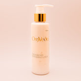 OmVeda moisturising lotion bottle with pump, white bottle and golden pump top