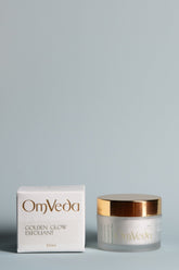OmVeda Golden Glow exfoliant jar and carton, white container with gold lid