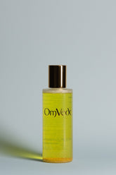 OmVeda Golden Glow toner bottle with gold cap, yellow translucent liquid