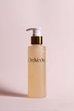 OmVeda Green Apple Shampoo pump bottle with gold cap; amber bottle