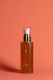 Harmony body oil 100 ml bottle with gold pump and amber liquid