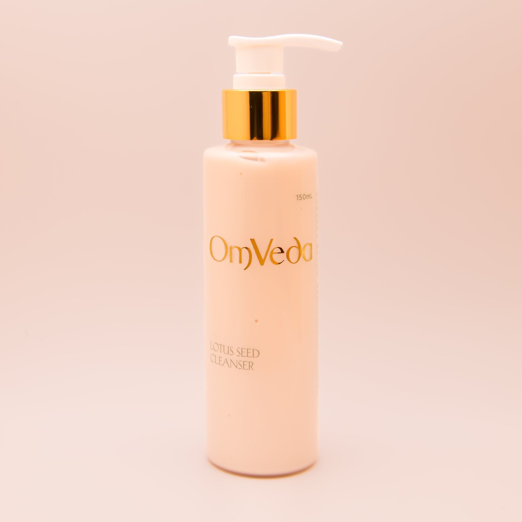 OmVeda lotus seed cleanser pump bottle, white bottle with gold pump, front view