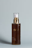 OmVeda body oil 100ml bottle with gold pump, dark amber massage oil in glass