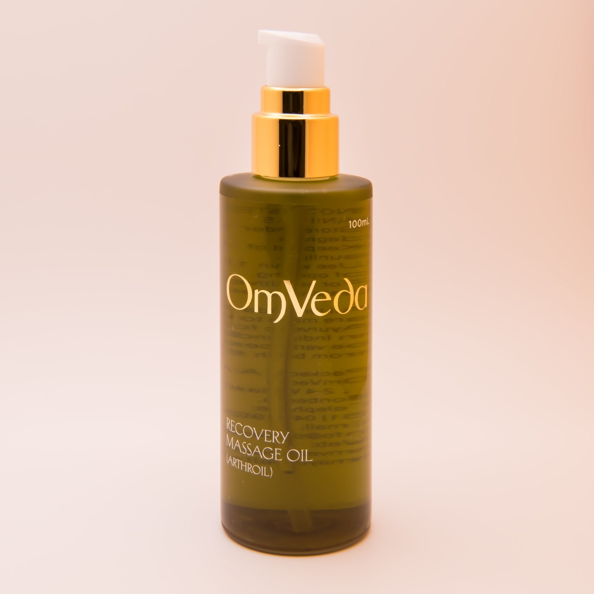 OmVeda recovery body oil 100 ml bottle with gold pump and amber-green liquid