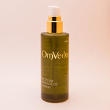 OmVeda recovery body oil 100 ml bottle with gold pump and amber-green liquid