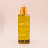 OmVeda Kapooradhi revive body oil bottle with amber liquid and gold pump, 100ml