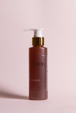 OmVeda amla shampoo bottle with white pump, brown bottle