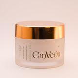 OmVeda brightening night cream jar with back label, gold lid