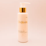 OmVeda moisturising lotion bottle with pump, white bottle and golden pump top