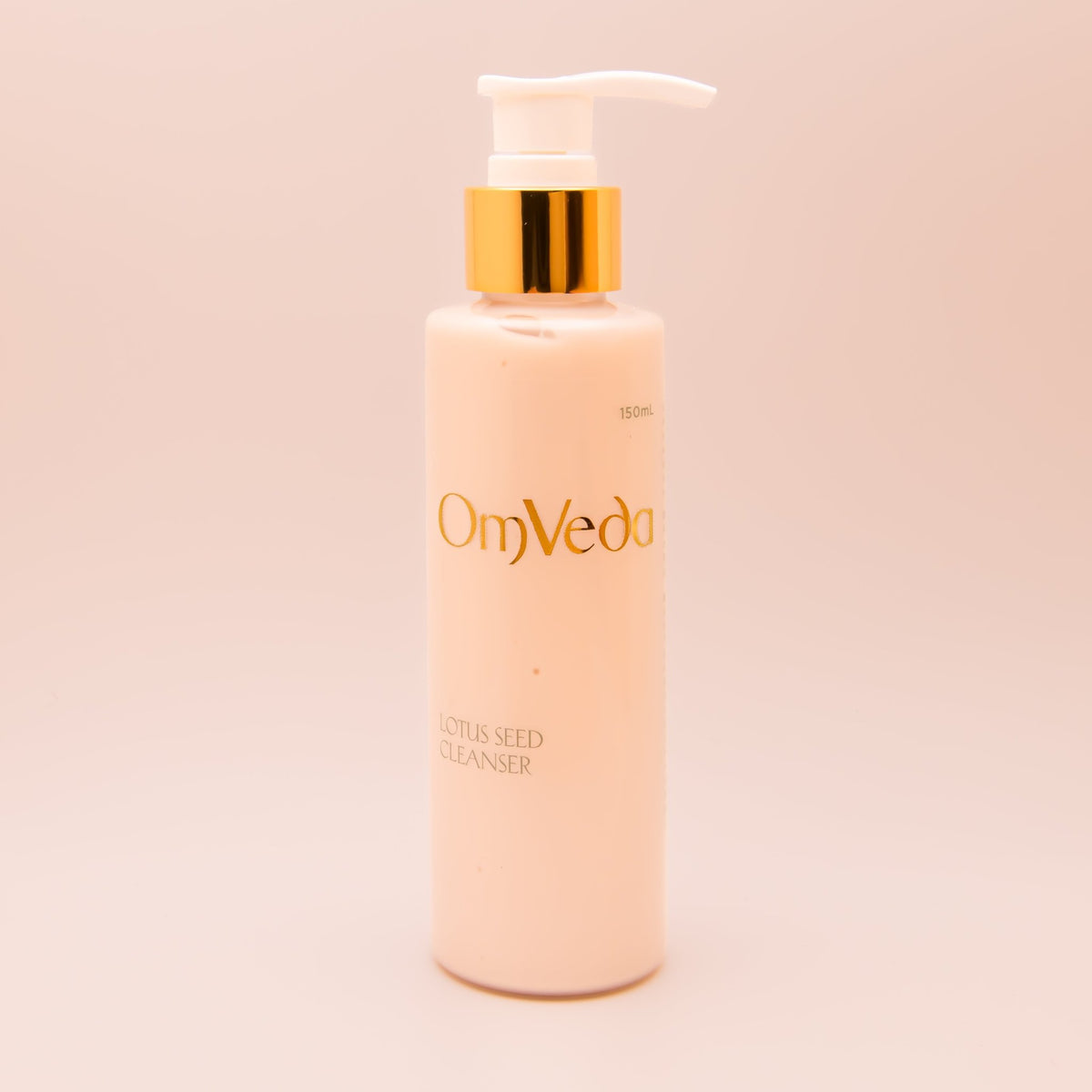 OmVeda lotus seed cleanser pump bottle, white bottle with gold pump, front view