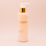 OmVeda lotus seed cleanser pump bottle, white bottle with gold pump, front view