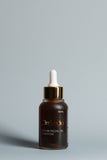 OmVeda saffron facial oil dropper bottle, amber glass with gold collar and white cap