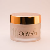 OmVeda walnut facial scrub jar with gold lid, cream-colored jar